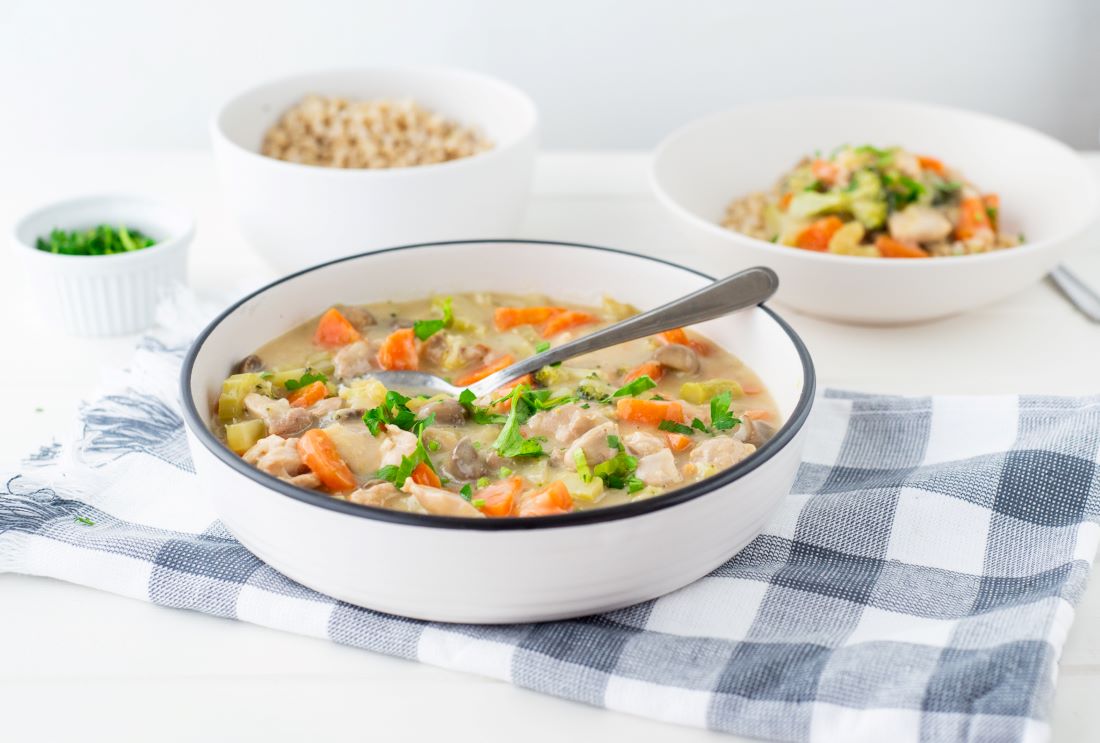 2 bowls of Chicken and vegetable casserole with a bowl of rice to the rear