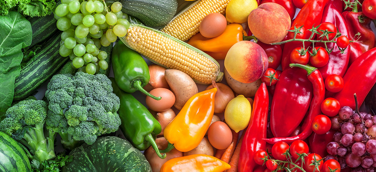 Fruits and vegetables overhead assortment colorful background green, yellow to red