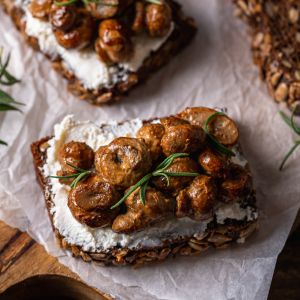 Sauteed mushrooms on a thin layer of cream cheese topping grainy slice of toast