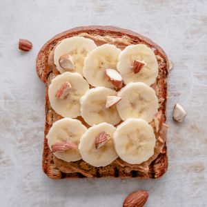 Peanut butter and sliced bananas on top of wholemeal bread