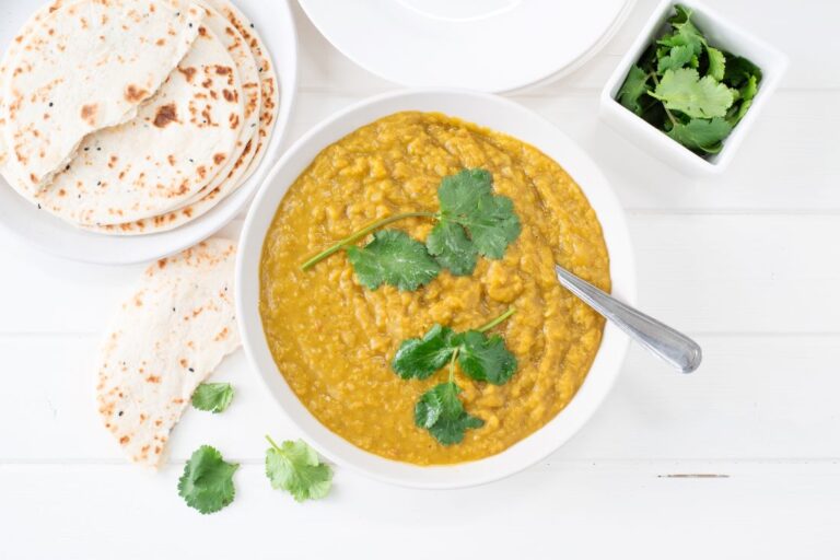 Red lentil dahl on brown rice in bowl