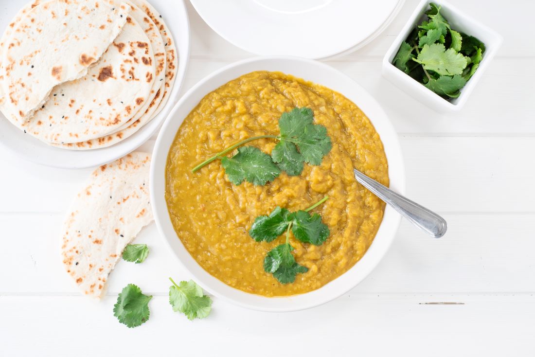 Red lentil dahl on brown rice in bowl